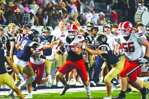 Wade Cheek/The Clayton Tribune. Wildcat sophomore Reid Giles breaks multiple tackles on his way into the end zone for his first of two TD’s in the 38-7 win over Whitefield Academy. Giles totaled almost 200 yards of total offense in the game.