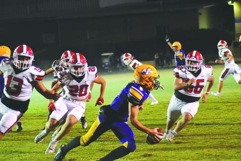 Wade Cheek/The Clayton Tribune. Athens Christian QB Matt Wiggins tries to avoid the Wildcats’ rush on Oct. 20 in a region contest won by RCHS 38-0. The Wildcats, who play Commerce this week, held the Eagles to negative 7 yards total offense. 