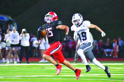 Wade Cheek/The Clayton Tribune. Wildcat sophomore running back Reid Giles wins a 64-yard foot race to score RCHS’s first touchdown in Sept. 29’s 42-28 victory of Fellowship Christian School. The Wildcats ran for a school-record 411 yards.