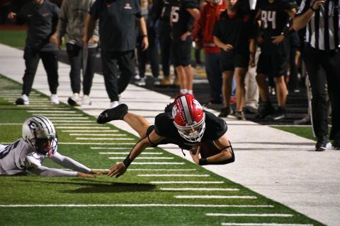 Wade Cheek/The Clayton Tribune. RCHS wide receiver Riley Stewart dives for extra yards in Blue Devil territory during last Friday’s region matchup against Elbert County. Yards were not as easy to find for the Wildcats as they fell 21-9.  