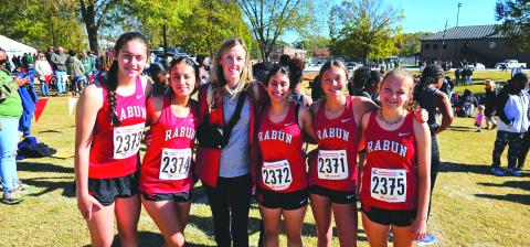 Submitted. The Lady Cat cross country team poses for a photo with their head coach April Adcock at last Friday’s state meet in Carrollton. The Lady Cats finished 14th in state despite many injuries and illnesses during the season.