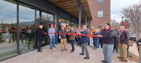 Megan Horn/The Clayton Tribune. Local officials and community members celebrate as the Bridge Creek Inn cuts the ribbon with Forward Rabun/Rabun County Chamber of Commerce during the Open House event Nov. 25. 