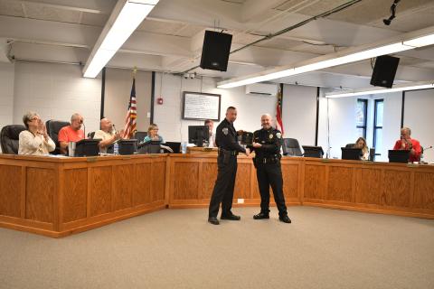 Megan Horn/The Clayton Tribune. Clayton Police Department Assistant Chief John Grist is recognized for 15 years of exemplary service to the city and is presented with a plaque by Chief Andy Strait on Oct. 17. 