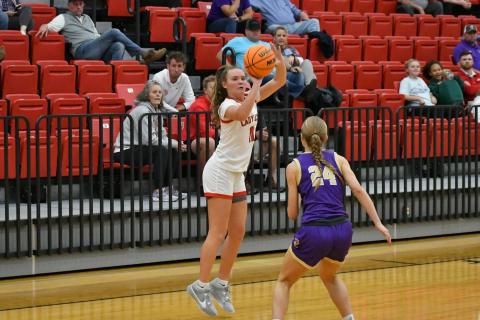 Wade Cheek/The Clayton Tribune. Western Carolina signee Lucy Hood releases her shot in a Lady Cat win over Union County Tuesday. In the background, Hood’s mother Amy Hood and RCHS head boys basketball coach David Adcock watch.