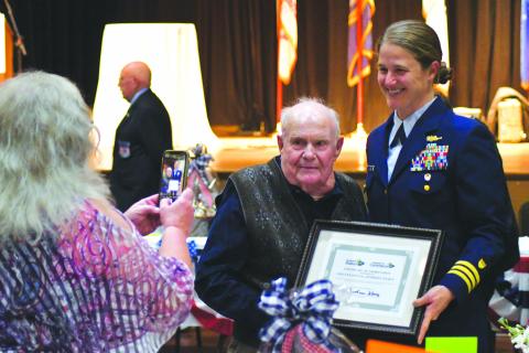 Enoch Autry/The Clayton Tribune. Kathy Causey takes a photograph of her father Eldrid Causey with Commander Sarah Ernst at the conclusion of the 24th Annual Veterans Appreciation Dinner on Nov. 9 at the Rabun County Civic Center. Ernst told the audience about 99-year-old Causey who served in WWII and was the oldest veteran at the event.