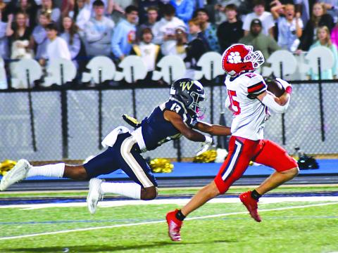 Enoch Autry/The Clayton Tribune. Wildcat running back Reid Giles breaks multiple tackles at the line of scrimmage and then outraces John Durden and other Whitefield Academy WolfPack defenders 56 yards for a touchdown. Reid led the Wildcats in rushing with 104 yards and two scores in RCHS’s 42-14 win to move into the state Elite Eight.