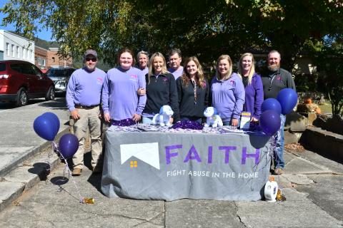 Megan Horn/The Clayton Tribune. Fight Abuse in the Home (F.A.I.T.H.) organized many events during October for Domestic Violence Awareness Month, including a Hope Walk where many community members walked in downtown Clayton while local businesses stood in solidarity holding candles on the sidewalk to bring awareness. 
