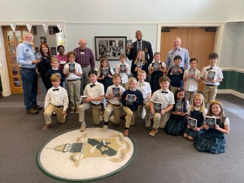 Submitted photo. Rotary Club members present dictionaries to third grade students at Rabun Gap-Nacoochee School. 