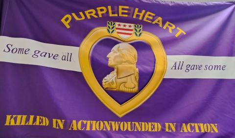 Megan Horn/The Clayton Tribune. The City of Sky Valley has been proclaimed ‘A Purple Heart City’ and displays this purple/gold flag at City Hall. 