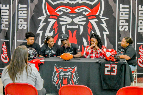 Wade Cheek/The Clayton Tribune. Rabun County Wildcat standout Willie Goodwyn signs his letter of intent to play football for the University of Cincinnati Bearcats Monday.