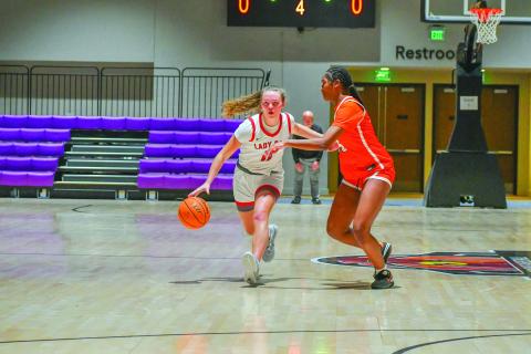 Wade Cheek/The Clayton Tribune. ady Cat senior guard Lucy Hood searches for an open teammate against Chambers High School during Rabun County’s 42-17 win in the Insider Exposure Cherokee Invitational on Dec. 20. Hood, who is headed to Western Carolina on a basketball scholarship, totaled 40 points across the three-day tournament. 