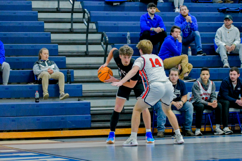 Wade Cheek/The Clayton Tribune. Senior forward Cooper Welch sizes up a West Oak defender during last Friday’s (Dec. 22) win over the Warriors. 
