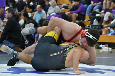 Wade Cheek/The Clayton Tribune. RCHS senior wrestler Justin Cody twists and pins a Murphy High School opponent during this year's King of the Mountain Invitational.