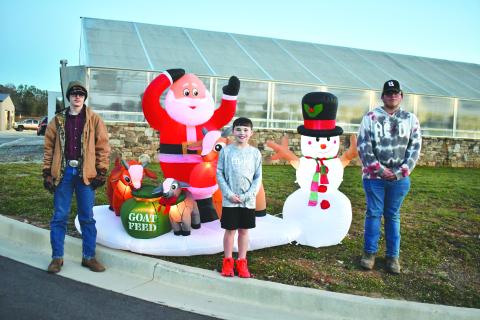 Megan Horn/The Clayton Tribune. FFA member Preston Patterson, Cayden McClain and FFA member Garrett Craig were among those who were in attendance at the Dec. 7 first-ever “Santa and Elves on the Farm” at the agricenter. 