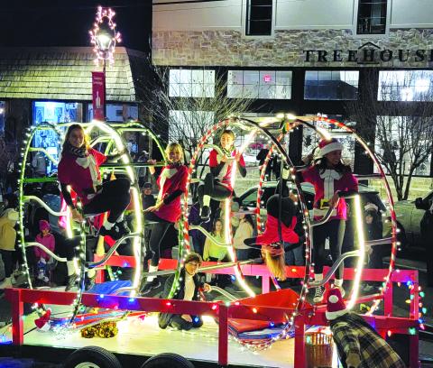 Enoch Autry/The Clayton Tribune. Rabun Gap-Nacoochee School students perform cirque maneuvers on their float in the Clayton Christmas Parade to help them win the “Best Overall” honors. The RGNS dance team also performed.