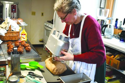 Megan Horn/The Clayton Tribune. Anne Weingartz kneads fresh dough made from wheat she milled herself at Quizzical Farm Bakery in Rabun Gap.