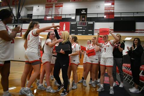 Enoch Autry/The Clayton Tribune. With her Lady Cat players surrounding her, Rabun County girls basketball coach  DeeDee Dillard hugs senior Mili Watts after Dillard logged her 400th career coaching win with a 49-38 triumph over region foe Commerce at home on Jan. 10. Dillard began coaching at RCHS in 2006.