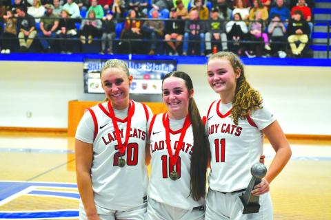 Wade Cheek/The Clayton Tribune. Senior guards (from left) Ellie Southards, Mili Watts and Lucy Hood pose with their well-deserved hardware after winning the 29th-annual Battle of the States tournament in Towns County on Dec. 30.
