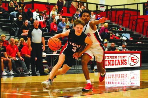 Wade Cheek/The Clayton Tribune. RCHS’s Huey Blalock drives to the hoop against Stephens County.