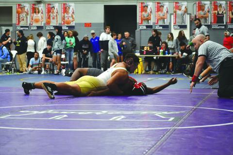 Wade Cheek/The Clayton Tribune. RGNS senior wrestler and football player Kaleb McKenzie pins his opponent to advance to the quarterfinal-round of the 285-pound weight class during Rabun Gap’s tournament at West Oak High School.