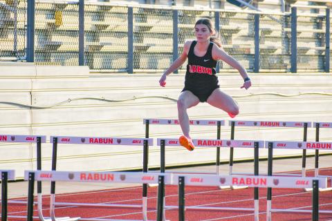 Wade Cheek/The Clayton Tribune. RCHS senior track runner Christina Keller glides through the girls 100 hurdles event during Rabun County’s season opener at Frank Snyder Memorial Stadium in Tiger on Tuesday, Feb. 20.