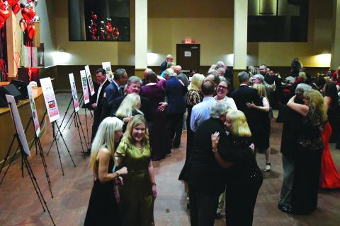 Enoch Autry/The Clayton Tribune. The 24th annual Sweetheart Ball for F.A.I.T.H. was held at the Rabun County Civic Center as the primary fundraising event to support operations of the domestic violence shelter, Power House Child Advocacy and Rape Crisis Center. ABOVE: With the Party At The Limit Band playing, couples dance while friends talk about the auction packages. Left: Jim Roberson dances with his wife Susan to the live music played by the band Party At The Limit. 