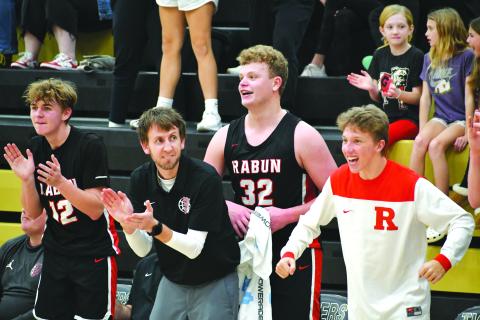 Wade Cheek/The Clayton Tribune. RCHS head boys basketball coach David Adcock cheers on his Wildcats as his players Reed Burrell, Jack Hood and Colton Crane cheer on their teammates during a big performance against Commerce.