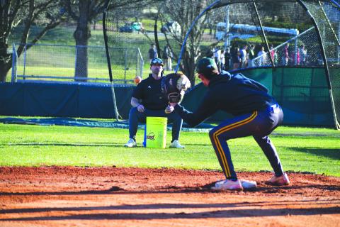 Wade Cheek/The Clayton Tribune. RGNS head baseball coach Clark Wright does infield work with Eagle senior Argenis Lopez at third base during a Feb. 13 practice. The Eagles will kick off their season Friday, Feb. 16 against North Atlanta at Pickens County High School. 