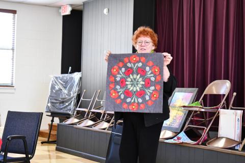 Megan Horn/The Clayton Tribune. Silke Cliatt showcases fabric art with a brightly colored Mandala made with slow hand stitching during the North Georgia Arts Guild “Show and Tell” showcase Feb. 15. Cliatt said the inspiration came from a Poppy flower. 