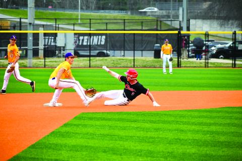 Wade Cheek/The Clayton Tribune. Diamond Wildcat senior Jarret Giles slides into second base safely to collect a stolen base against Athens Christian on Tuesday, March 5. Rabun County, however, lost 15-3 to the region foe Eagles. 