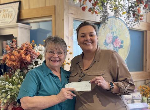 Submitted photo. Clayton Cafe Owner Bonnie Edmonds presents the donation check from the Feb. 19 Spaghetti Dinner ‘Raise a Fork for a Great Causes’ at Clayton Cafe & Market to Rabun Paws 4 Life Fundraising Chair Ara Joyce. The event raised $4,221 for the nonprofit. 