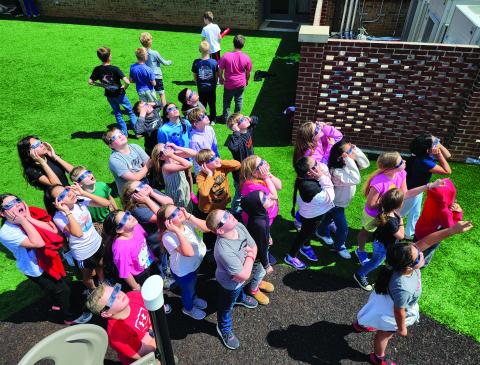 Enoch Autry/The Clayton Tribune. Wearing the eclipse shades, Rabun County Elementary School students gaze toward the sky during Monday’s solar eclipse. Left: Hudson Hamby sees the Eclipse in the sky Monday.