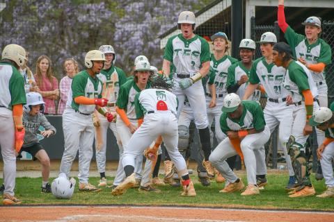 Wade Cheek/The Clayton Tribune. TFS baseball junior Danny Vigille-Grant slams his bat down in celebration with his teammates after his second home run during a Region 8 win over Rabun County High School. The Indians and Wildcats will face off two more time on Friday, April 5 during a double-header in Tiger. 