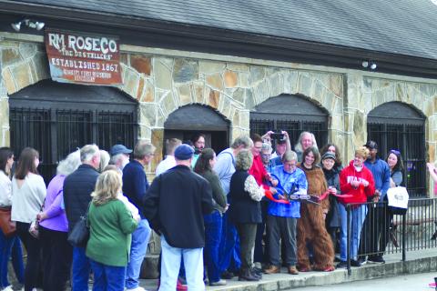 Enoch Autry/The Clayton Tribune. Dr. John Stamey cuts the ribbon for Forward Rabun and Rabun County Chamber of Commerce. 