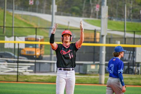 Wade Cheek/The Clayton Tribune. Cooper Welch celebrates in the direction of his Wildcat teammates in Rabun County’s 8-1 win over Barrow Arts and Sciences at home on April 8.