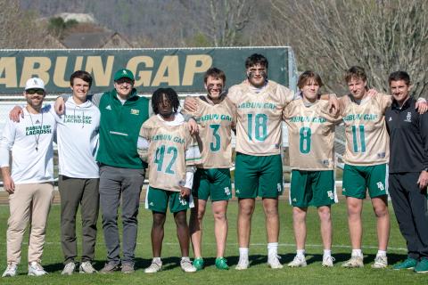Wade Cheek/The Clayton Tribune. RGNS across head coach Ryne Linsley and the RGNS coaching staff stands with the Class of 2024 during Senior Night on Friday, April 5. The lacrosse Class of 2024 includes Huseyin Simsir, Danny Beccan, Will Brien, Cael Woody and Jack Moores. 
