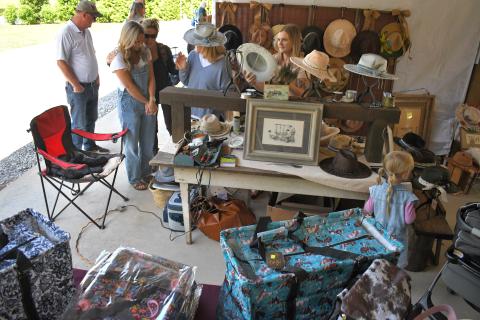 Enoch Autry/The Clayton Tribune. On a sunny day at the Of These Mountains event in Clayton, hat shopping is a must at the Rabun County Civic Center pavilions.
