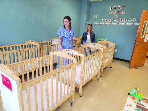 Enoch Autry/The Clayton Tribune. Assistant Director Hannah Cannon and Director Tiffany Prescott check the cribs in The Creative Learning Center’s infant program, set to open Aug. 5.