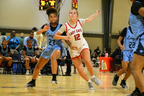 Wade Cheek/The Clayton Tribune. RCHS junior guard Conley Spivey battles for position to earn a rebound during the Lady Cats’ summer game against Lovejoy on Friday, June 14. at the LakePoint Sports complex in Atlanta. 