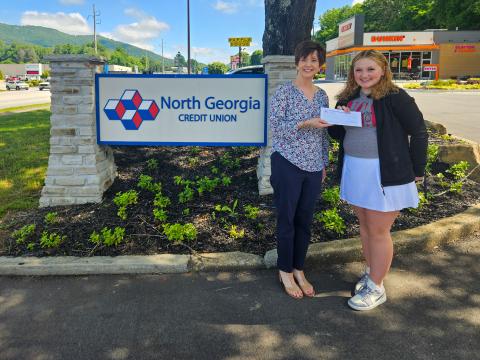 Submitted photo. Carrie Kuehne, North Georgia Credit Union member service representative, awards Rabun County High School 2024 graduate Ashlynn Blackwell with the Rabun County scholarship from the local credit union.