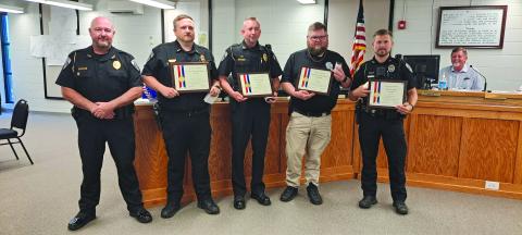 Megan Horn/The Clayton Tribune. Clayton Police Department Chief Andy Strait (from left) presents Investigator Matt Thomas, Assistant Chief John Grist, Sgt. Andy Beck, and Officer Justin Buchanan with awards and medals for their heroic actions and lifesaving efforts for an infant during a call March 5, 2024. The officers’ actions will be recorded in the American Police Hall of Fame. 