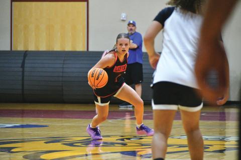 Wade Cheek/The Clayton Tribune. RCHS sophomore Adelyn Thompson surveys the court for an open pass during the Rabun County girls basketball team’s game versus Ringgold at Emmanuel University on June 10. Thompson was a reliable target from three-point range and will be looking to let the three’s fly during this upcoming season. 