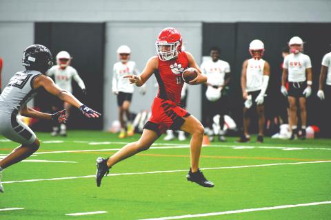 Wade Cheek/The Clayton Tribune. Rabun County football wide receiver Jake Payne speeds by an Alpharetta defender for a touchdown during a 7-on-7 camp at the University of Georgia on Thursday, June 20. The Wildcats played four games within the Bulldogs’ “House of Payne” indoor facility with a number of UGA football coaches and players watching. 
