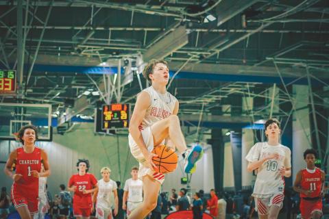 Wade Cheek/The Clayton Tribune. RCHS junior guard Huey Blalock goes between the legs for a fast-break layup during the Wildcats’ 29-point win over Charlton County at the LakePoint Sports Complex on Sunday, June 23. Blalock and the Wildcats finished this summer season 18-4. 
