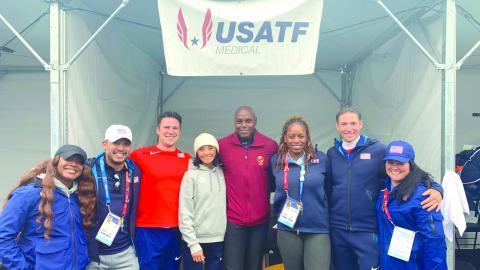 Submitted. Ena Weinstein (fourth from left) stands for a photo with former world-class Olympian and track star Carl Lewis (center) and other Team USA staff members during the 2023 Pan American Games in Chile. 