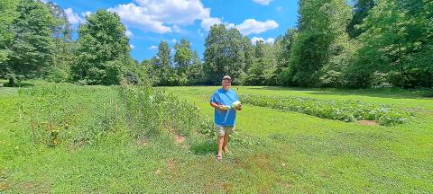 Megan Horn/The Clayton Tribune. Joey Davenport displays some of the vegetables he grew out of his local garden.