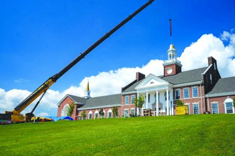 Submitted photo. Crews from Carroll Daniel Construction work to place the iconic Cupola back atop Hodgson Hall.