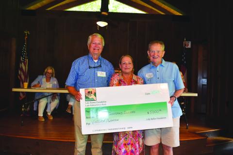 Submitted photo. Steve Raeber and Buz Stone present Victoria Anderson with the Buz Stone Award and $5,000 grant from the Lake Rabun Foundation.