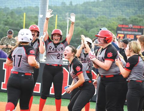 Wade Cheek/The Clayton Tribune. RCHS softball freshman River Evans touches home plate and celebrates with her Lady Cat teammates after she cracked a grand slam during Rabun’s home game against Lumpkin County on Thursday, Aug. 1. The Lady Cats fell to the Indians 15-11 while also falling to Towns County 11-10 on Monday, Aug. 5. 
