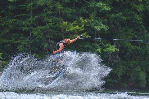Wade Cheek/The Clayton Tribune. Chase Andrews, an original founder of the Mountain Air Classic, flies backward through the wakes of Lake Burton during his strong run at the 24th running of the lake event. Andrews and 34 other competitors did their best wakeboarding last weekend on Saturday, Aug, 3. 